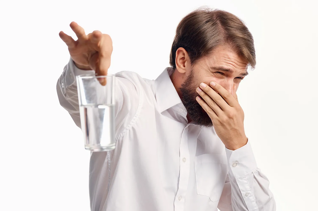 Man håller glas med illaluktande vatten